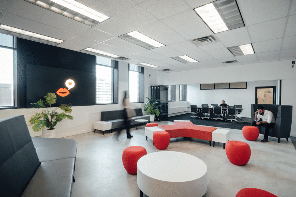 Lounge space with modern office furniture supporting a relaxed commercial office environment.