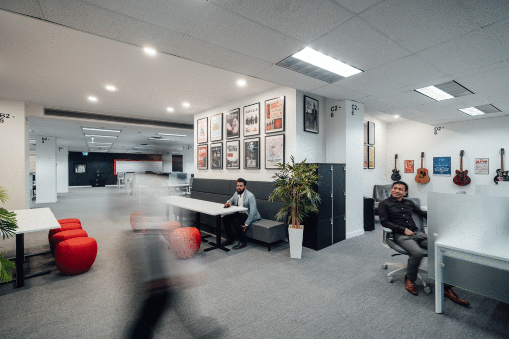 Comfortable lounge area with Virgin-branded decor and modern commercial office furniture.