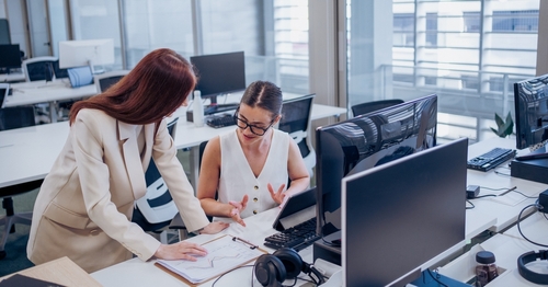 Team collaborating in a modern Canadian office equipped with smart office furniture and technology