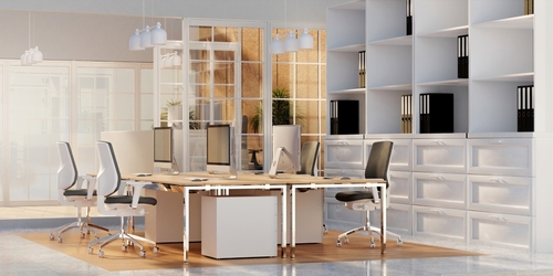 Modern open-concept office workspace with ergonomic chairs, shared desks, and contemporary storage furniture in Mississauga.