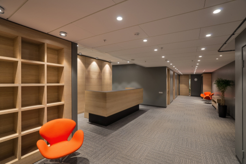 Modern office furniture in a Vaughan workspace featuring a contemporary reception desk and bright lounge seating.