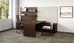 Private executive office featuring workspace furniture from The Office Shop, including an ergonomic chair, height-adjustable desk, and Canadian-made guest seating
