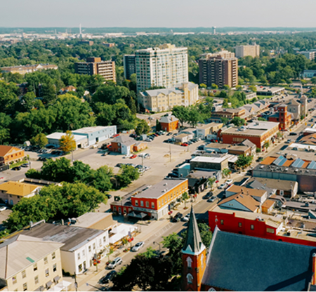 Aerial cityscape of Milton Ontario featuring high-rise residential buildings and commercial districts supported by The Office Shop for office furniture Milton projects