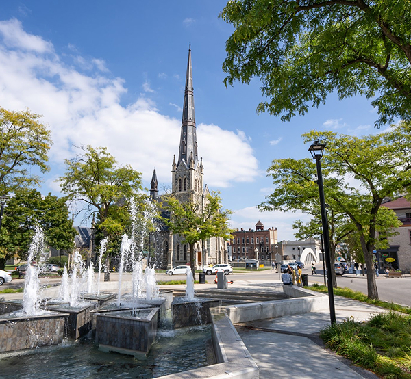Central Presbyterian Church and Queen's Square fountain in downtown Galt Cambridge Ontario, in the area served by The Office Shop for office furniture Cambridge solutions