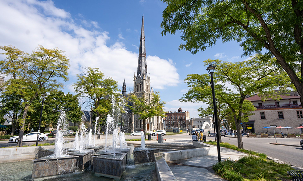 Downtown Cambridge Ontario streetscape featuring the historic church spire and Queen's Square supported by The Office Shop for office furniture Cambridge projects