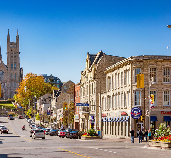 Historic Wyndham Street in downtown Guelph Ontario featuring limestone buildings and the Basilica supported by The Office Shop for office furniture Guelph projects