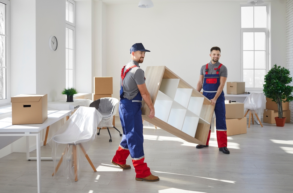 Team packing office furniture and equipment for a professional office furniture removal service before relocation.