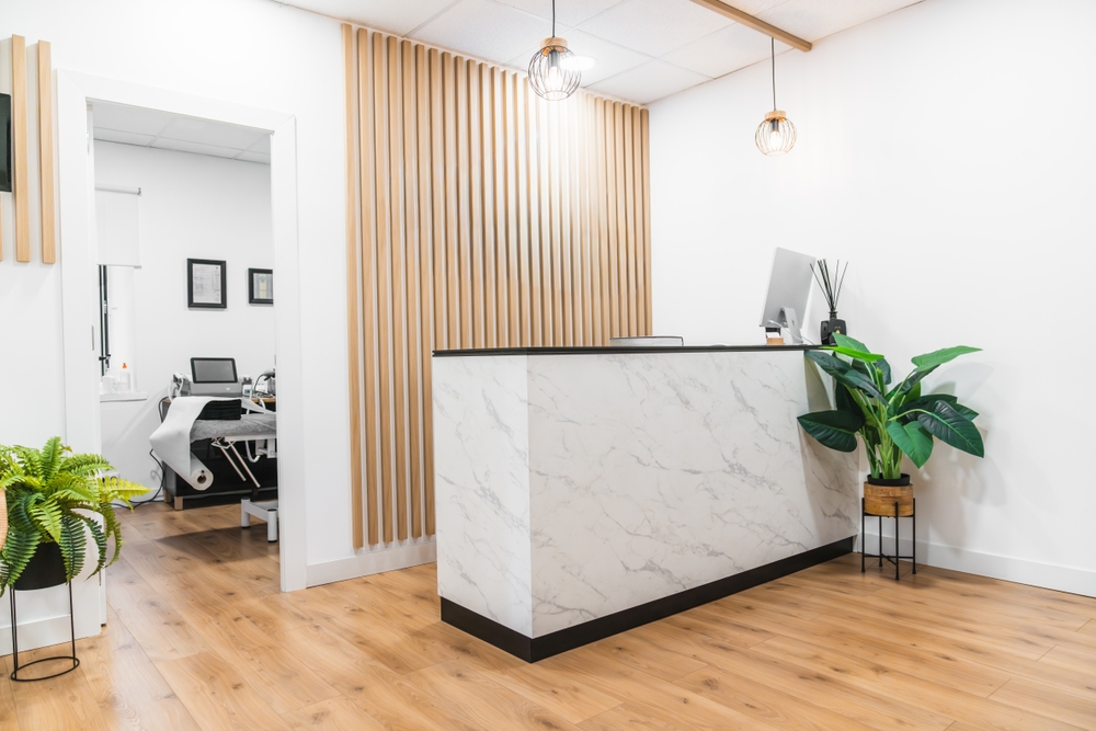 Modern business lobby featuring a contemporary office reception desk with ergonomic workspace elements and storage solutions.
