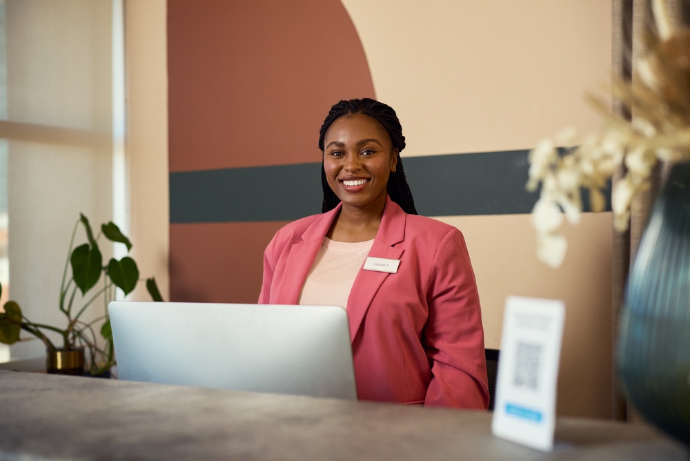 Sleek corporate lobby with a modern office reception desk designed for guest check-ins and front desk operations.

