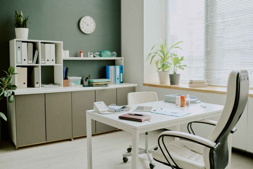 Professional office space with stylish office storage solutions including overhead cabinets, shelving, and workspace organization.