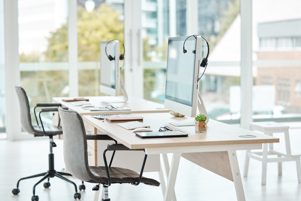 Modern furnished office with practical workstations and meeting areas demonstrating recommendations from an office furniture buying guide.