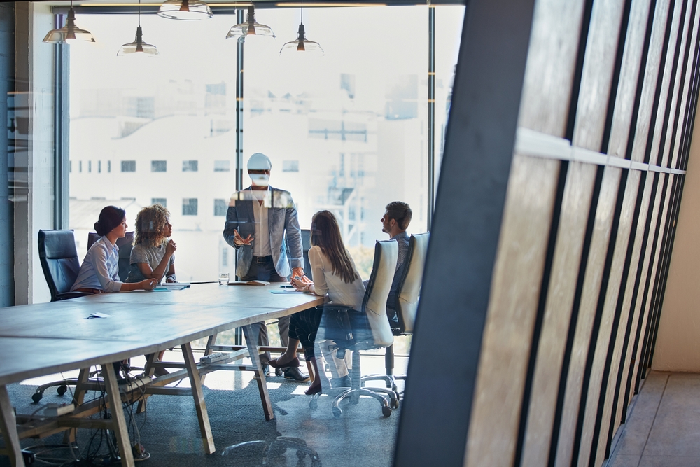 Contemporary corporate workspace showcasing premium commercial office furniture including desks, chairs, storage, and meeting areas.