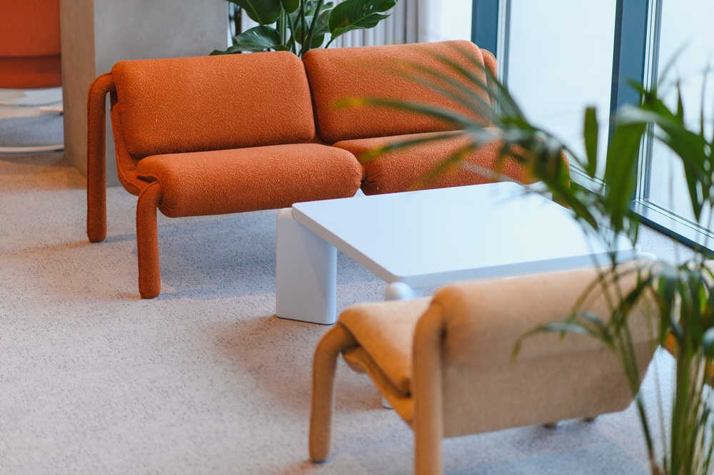 Office lounge furniture with modular sofas and a coffee table in a corporate reception area