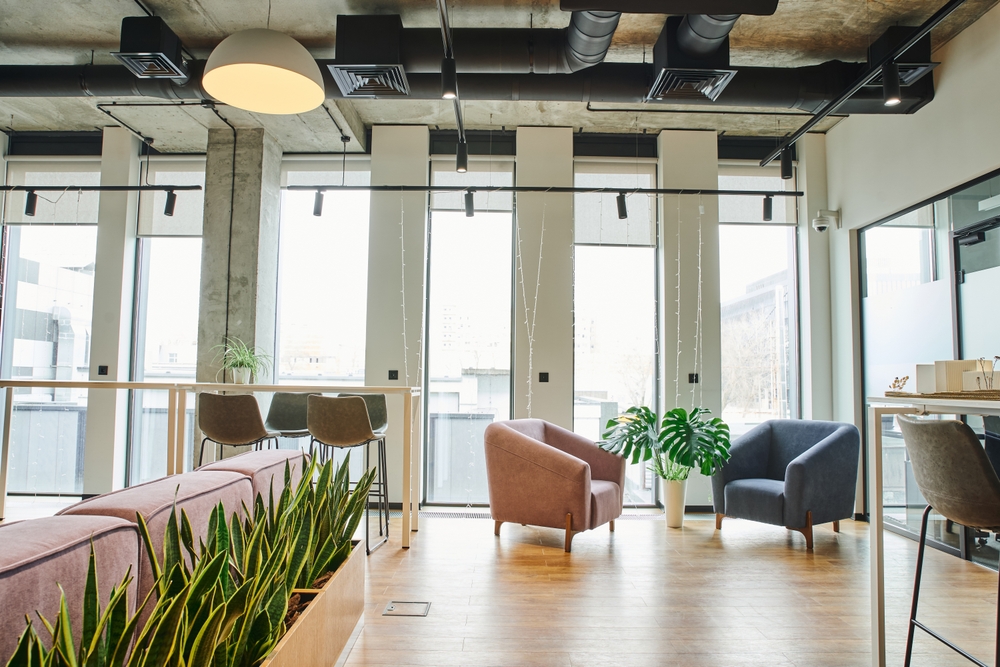 Modern office lounge furniture arranged in a bright breakout area for team collaboration