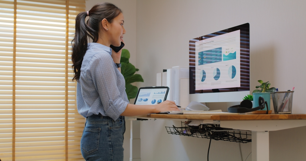 Electric height adjustable desk in a modern Toronto office workstation
