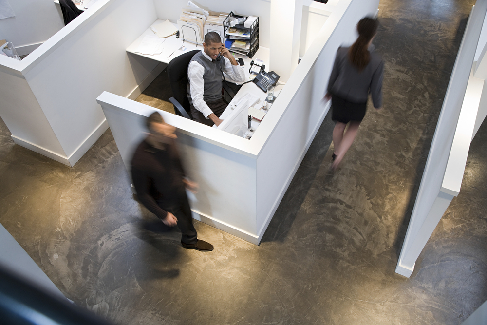 Rows of office cubicles with built-in storage in a corporate office setting