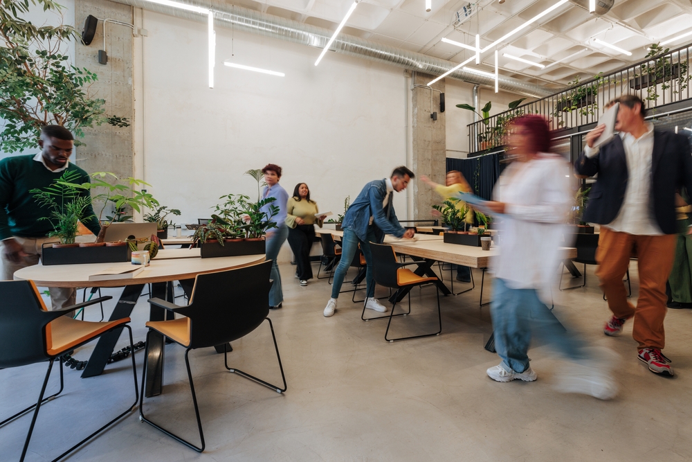 Ergonomic office chairs and sit-stand desks arranged in a new office after an office relocation checklist