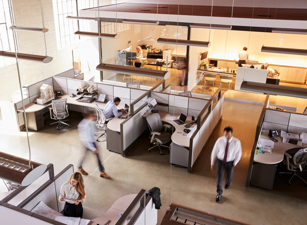 Office furniture reconfiguration layout with rearranged desks and ergonomic chairs in a modern office